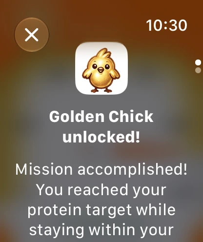 Apple Watch Golden Chick unlocked message celebrating a protein goal reached within calorie target